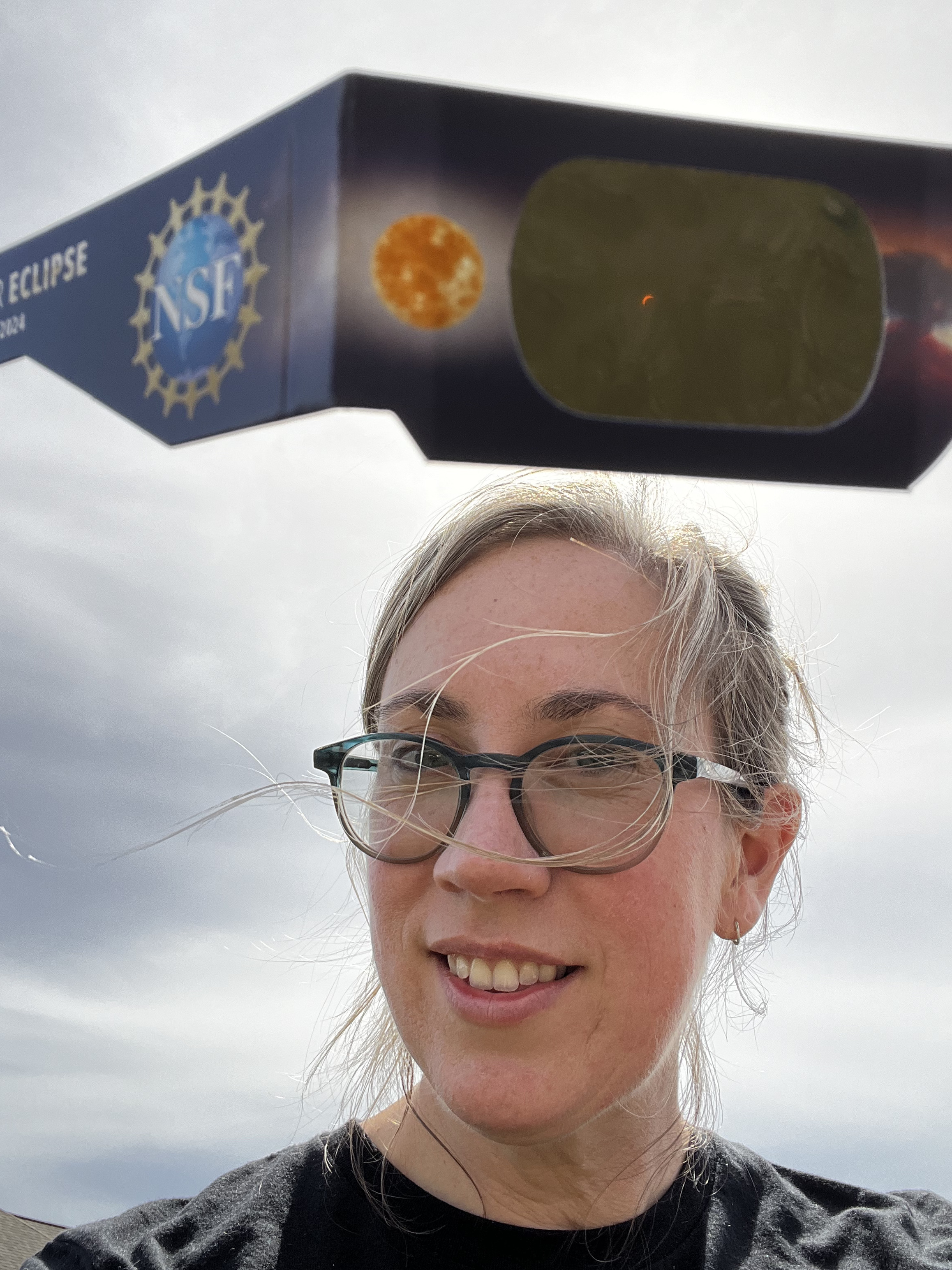 Me with a sliver of the sun visible through eclipse glasses, shortly before totality.