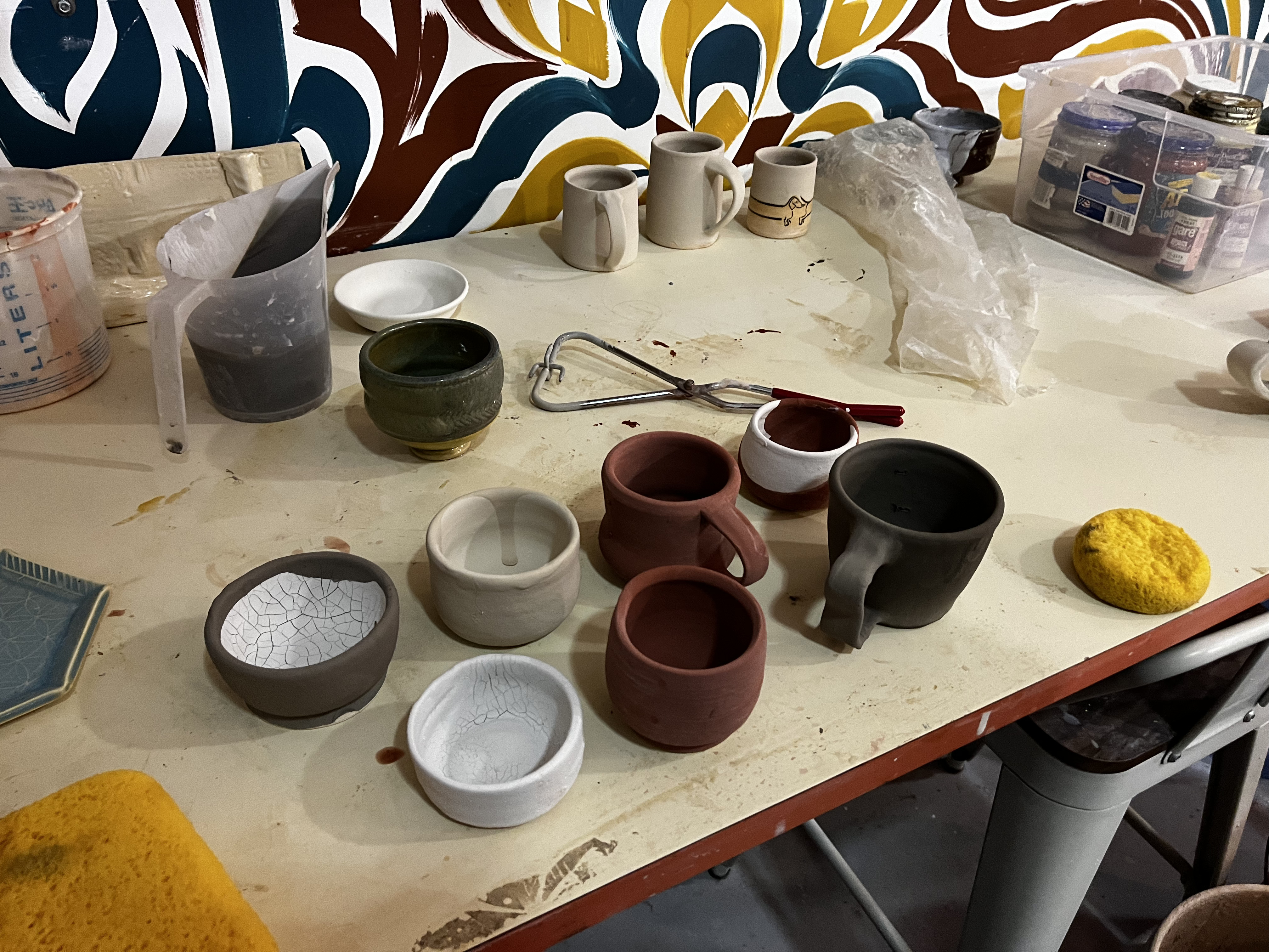 A collection of unfired glazed pieces.