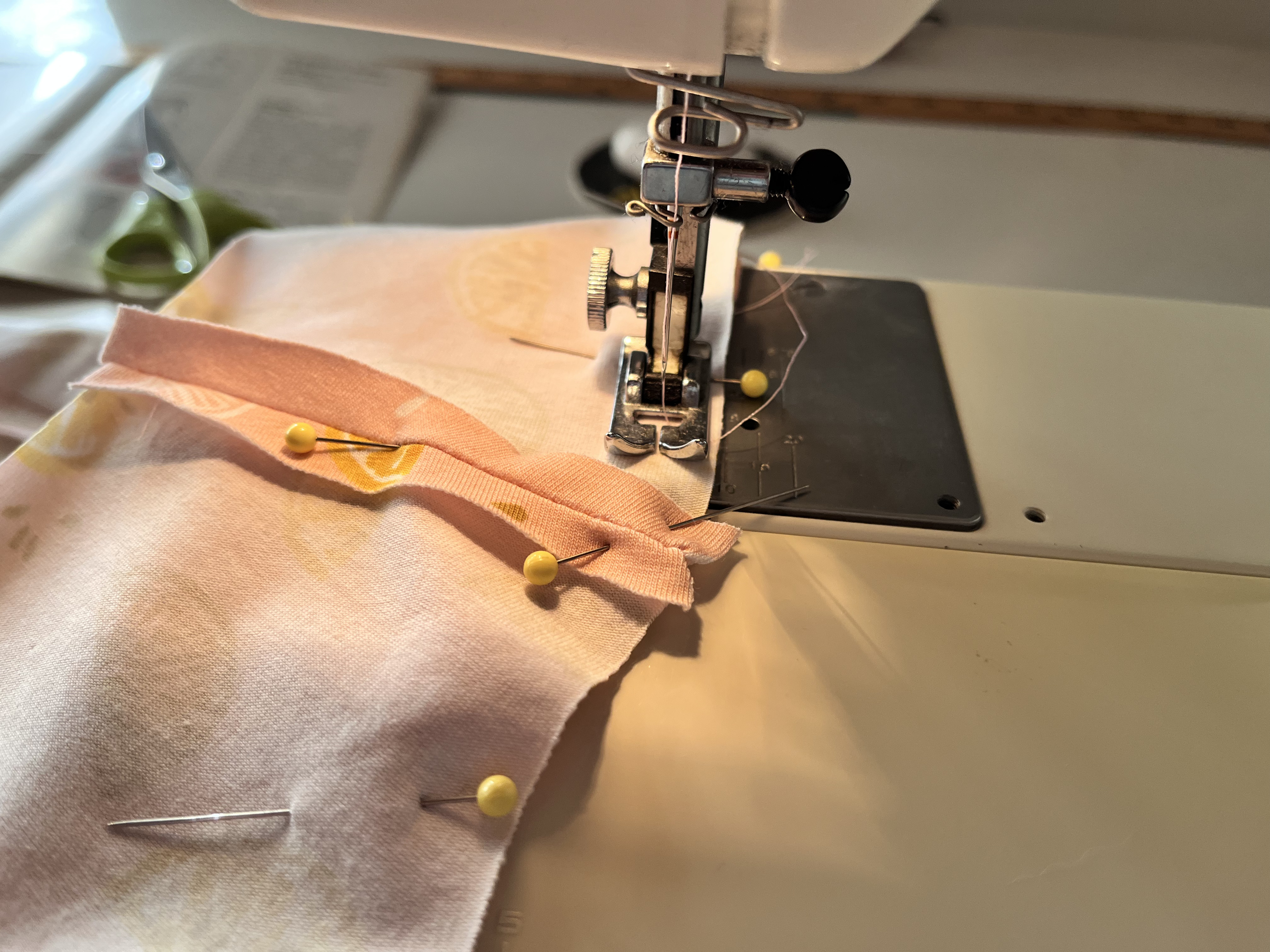 Close up of sewing lemon fabric in a sewing machine