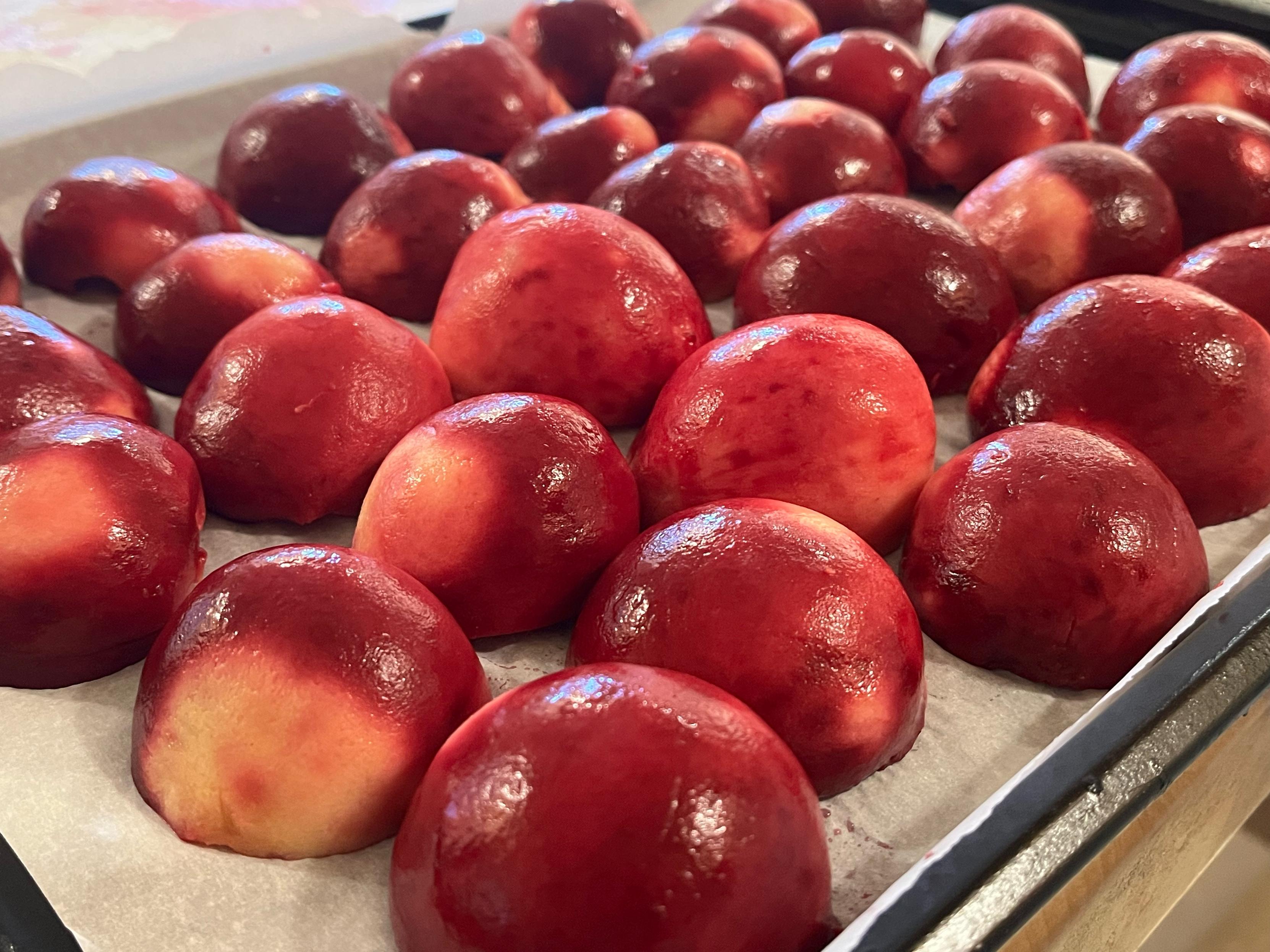 Closeup lower angle photo looking into mounds of lined up peach halves