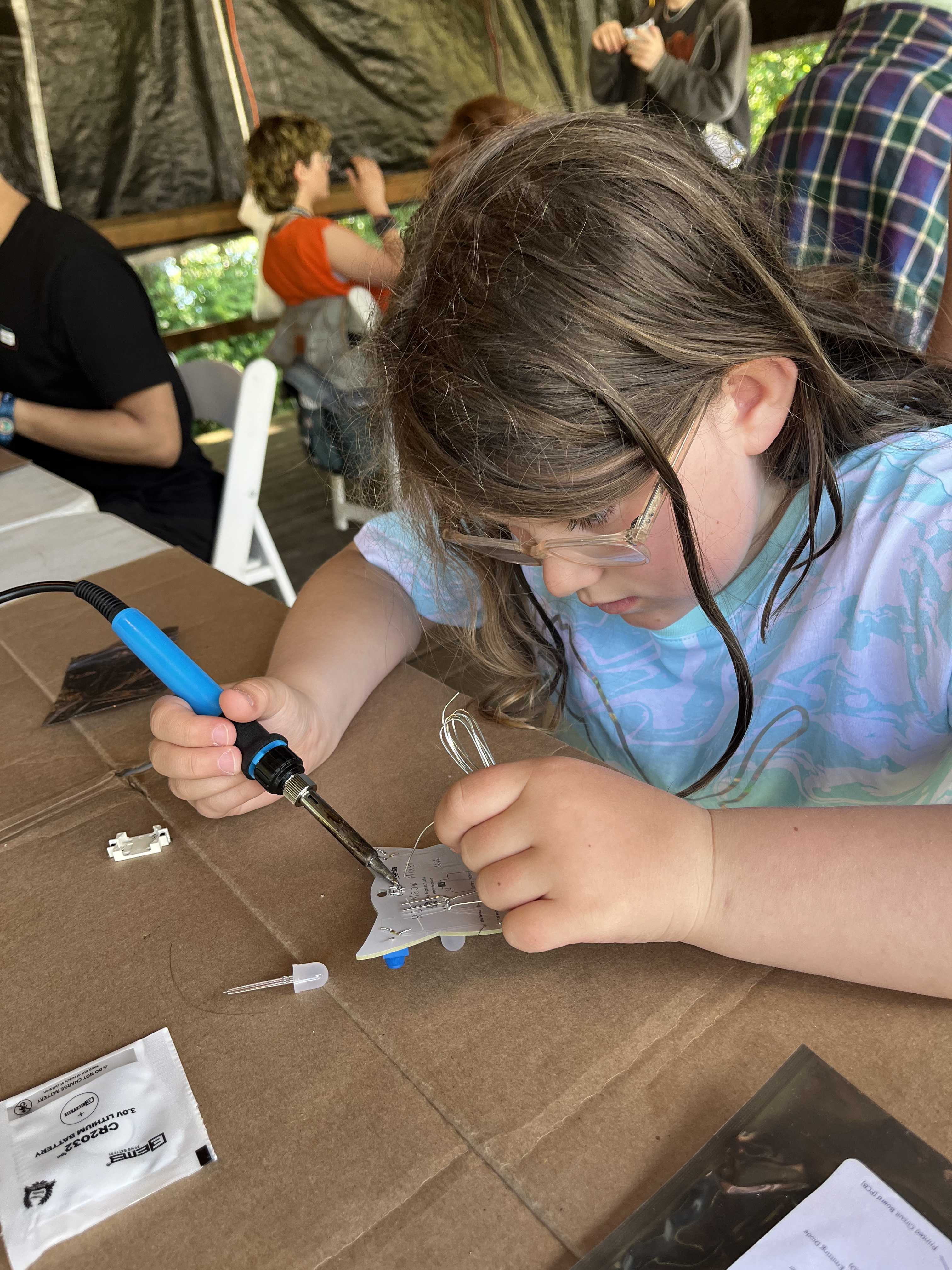 My daughter soldering a badge