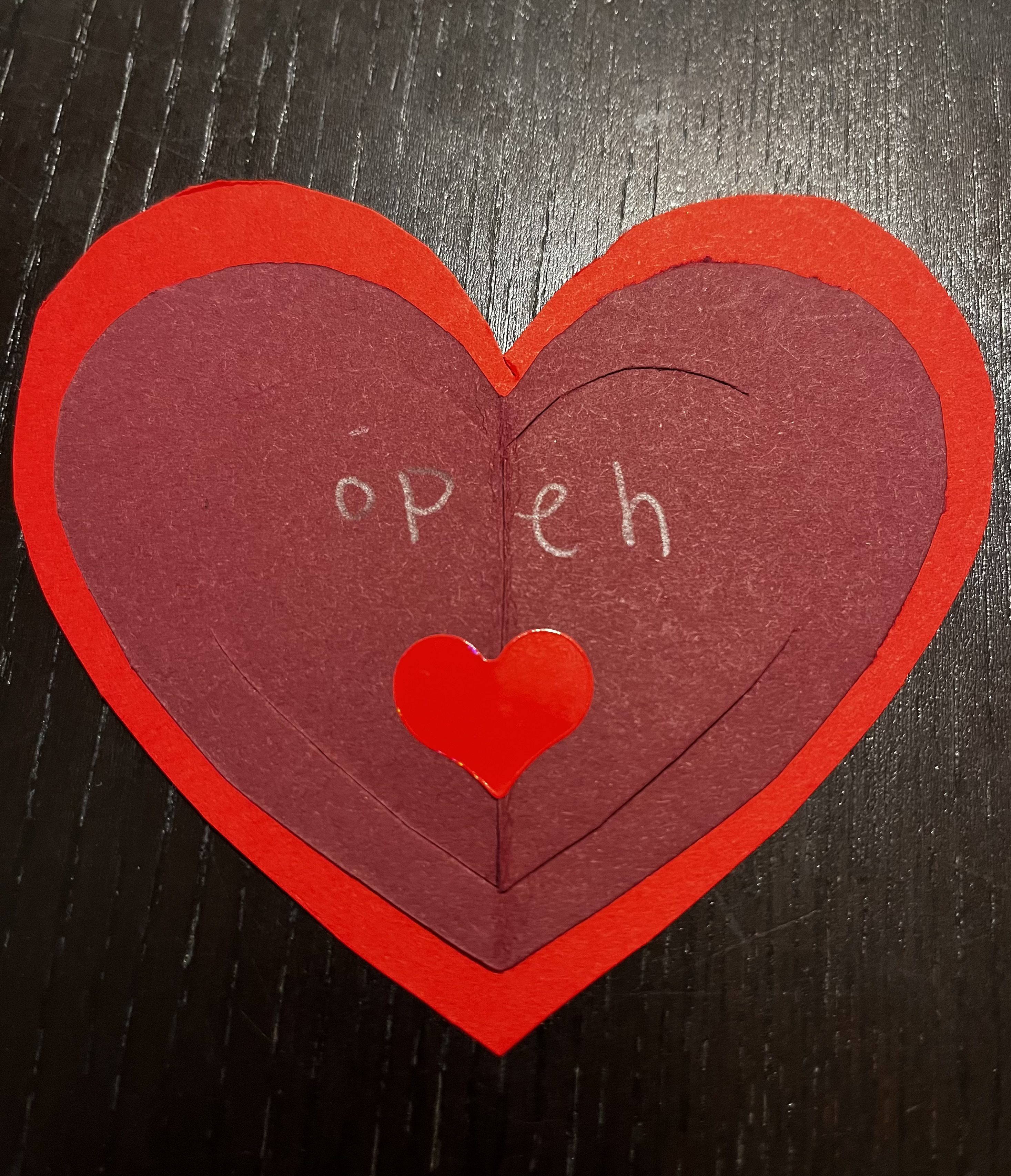 Heart sticker and “open me” hand-written in pencil